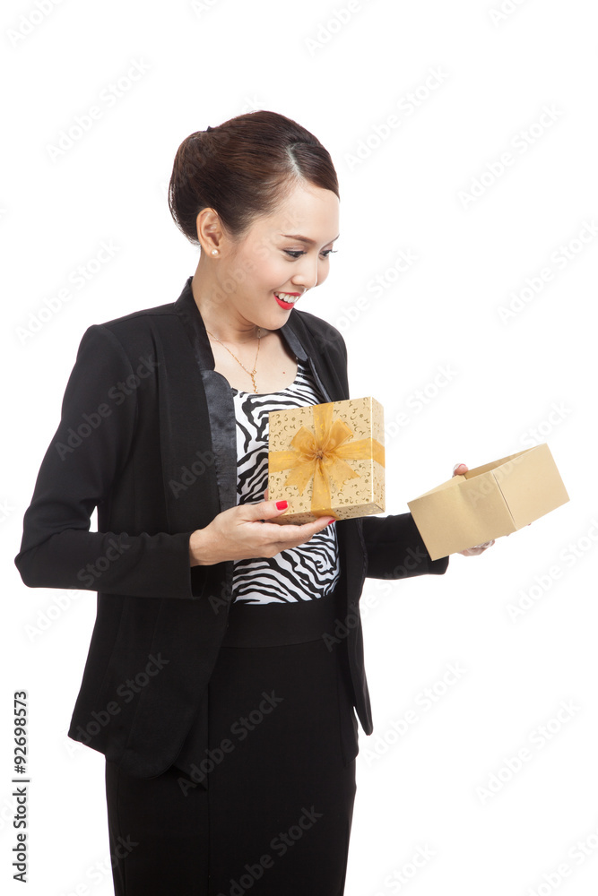 Young Asian business woman open a golden gift box Young Asian business woman open a golden gift box