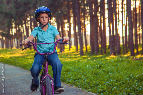 Fototapeta Naklejka Na Ścianę i Meble -  Little boy riding bike in nature.