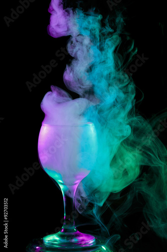 Blue - green - purple smoke in the glass. Halloween.