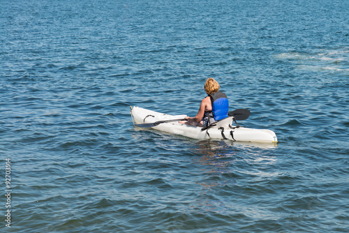 Lone female kayaking in the ocean © mdurson