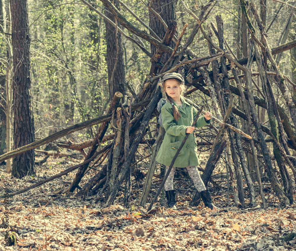 little girl in the wood near  hut