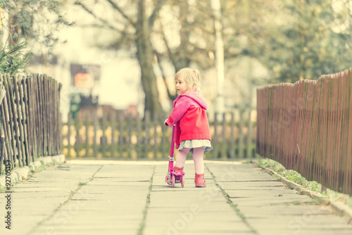 year-old girl riding her scooter