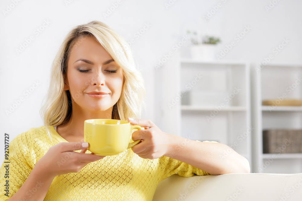 Beautiful woman enjoying the smell of coffee in the morning. Beautiful woman enjoying the smell of coffee in the morning.