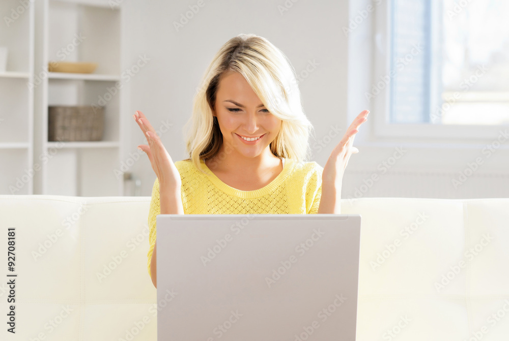 Beautiful blond woman with a laptop computer at home Beautiful blond woman with a laptop computer at home