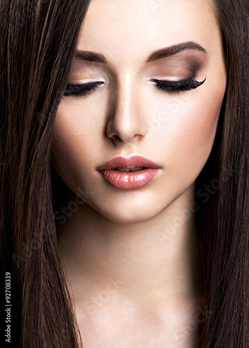 Obraz na plátně Face of beautiful young woman with brown make-up and  straight