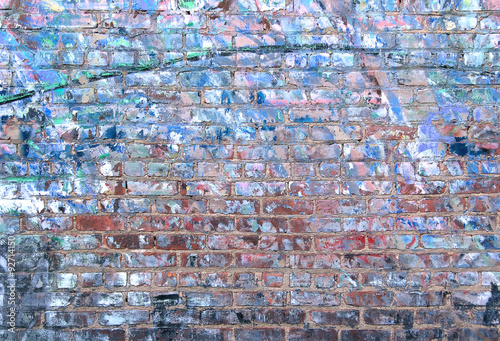 Grunge brick wall textured background with weathered blue paint