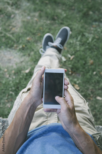 Young man with mobile phone...