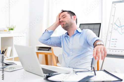 Photos Young attractive man too tired to work