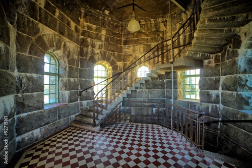 Staircase in a stone room inside a lookout tower. HDR image.