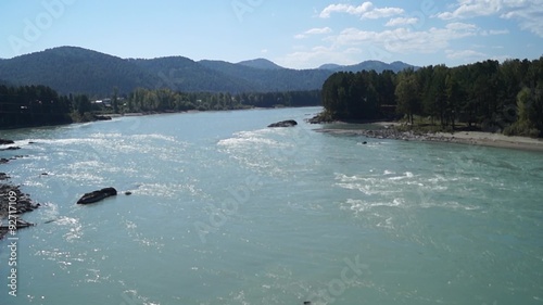 View from the suspension bridge over the river Katun in the summer with the surroundings.