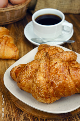 Croissant ready for breakfast on wooden table