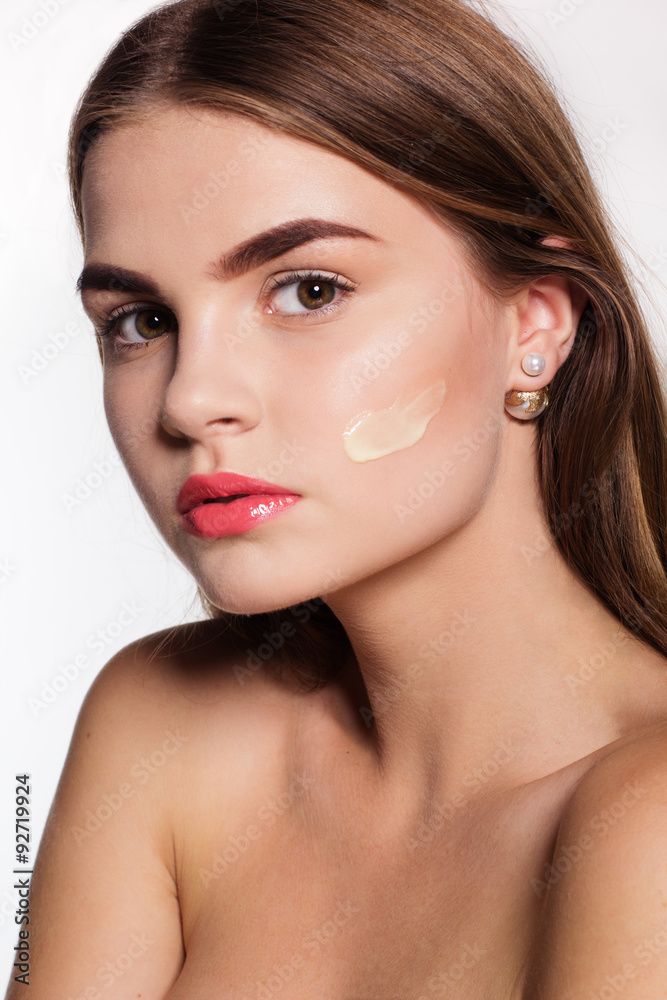 Girl with perfect skin and moisturizing cream