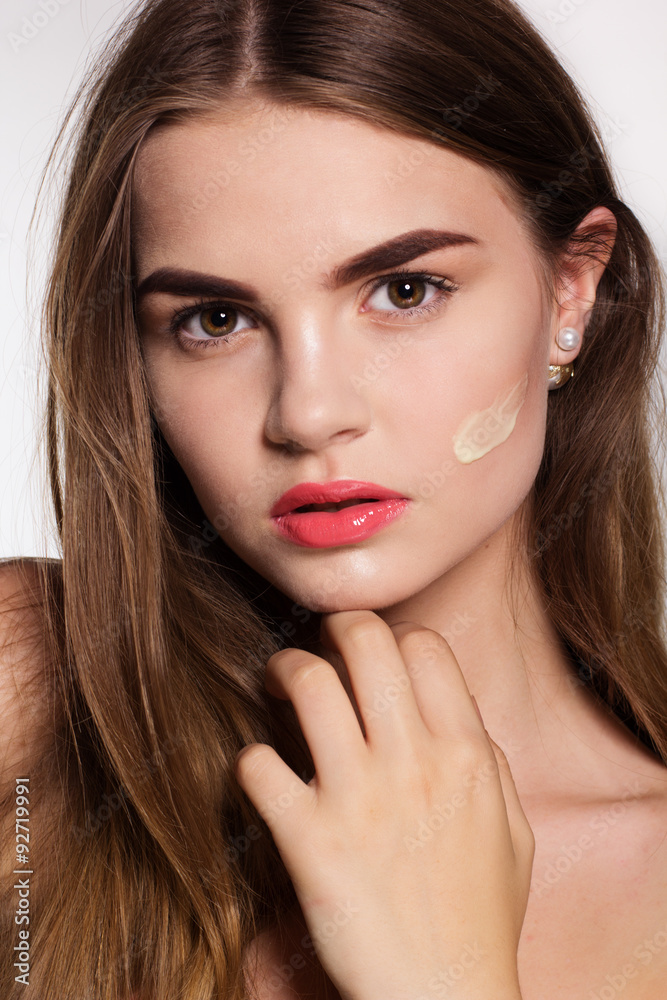 Girl with moisturizing facial cream Girl with moisturizing facial cream
