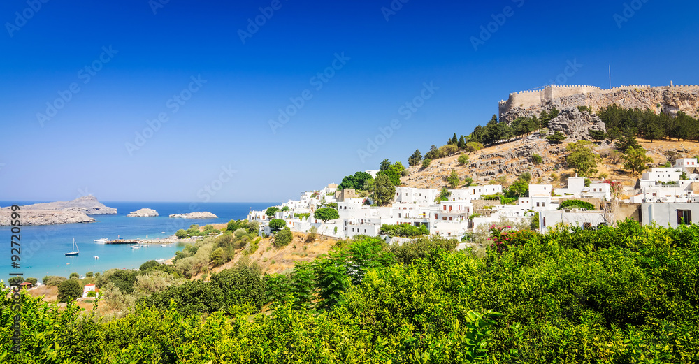Panorama for Lindos village with castle ruins above