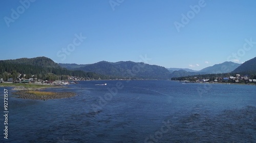Powerboat sailing on Lake Teletskoye and views of the villages Artybash and Iogach, and view of the lake in summer.