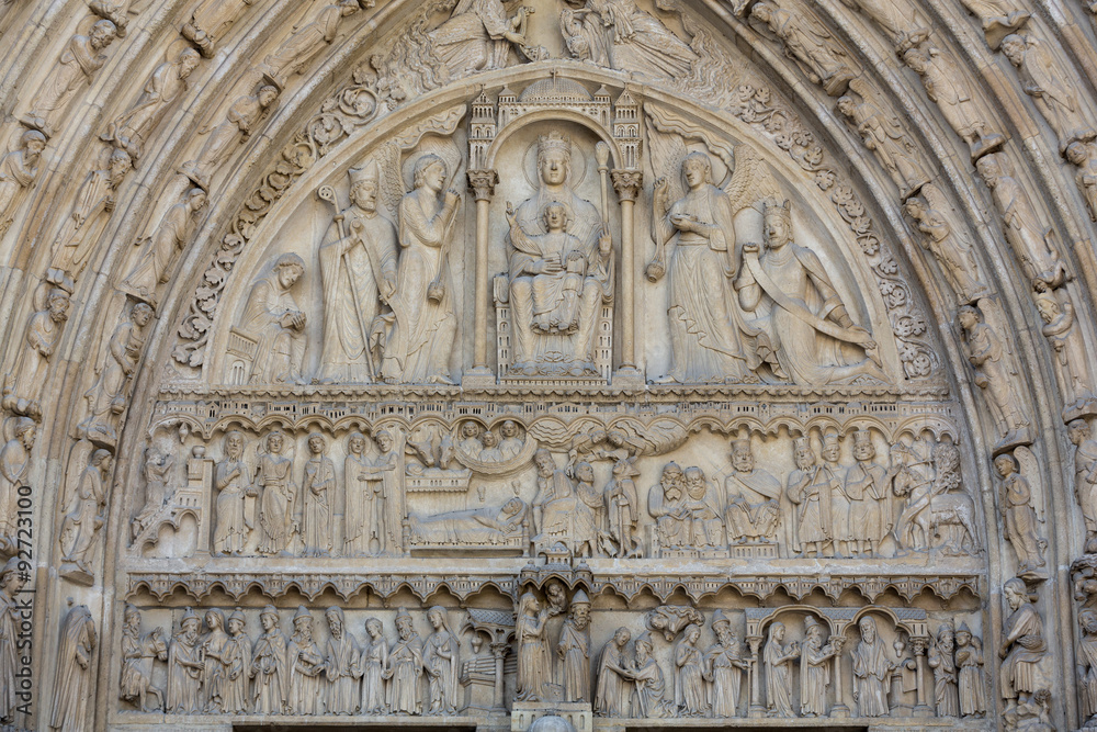 Paris - West facade of Notre Dame Cathedral. The Saint Anne portal and tympanum
