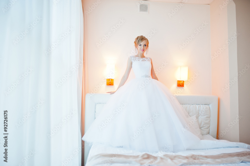 gentle blonde bride on couch tenderly posed gentle blonde bride on couch tenderly posed
