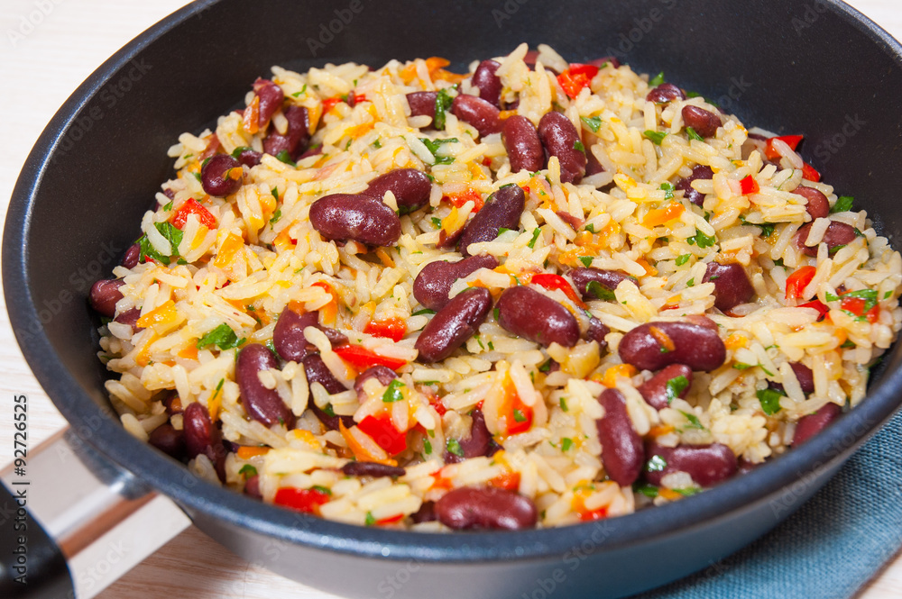 Rice with red beans and vegetables in a frying pan Rice with red beans and vegetables in a frying pan