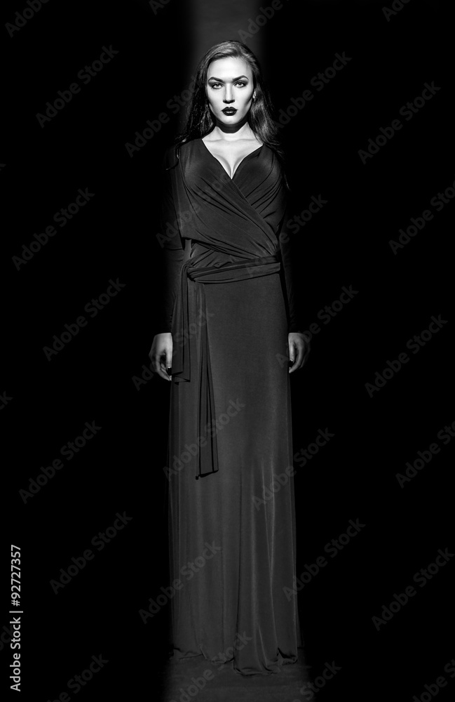 Beautiful Fashion model in black dress in studio,black and white photo