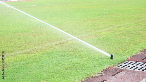 sprinker watering lawn photo