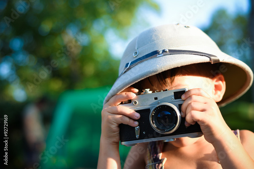 Kid taking photos using retro rangefinder camera