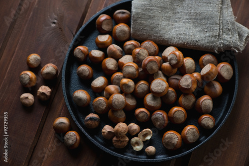 Top view of hazelnuts in a frying pan, close-up, selective focus