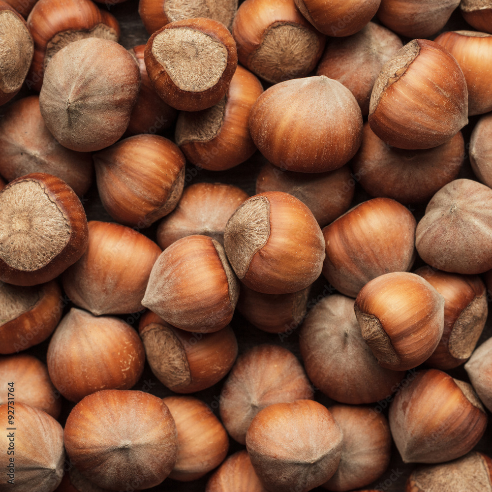 hazelnuts on the brown wooden table hazelnuts on the brown wooden table