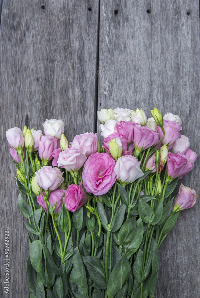 Beautiful bouquet of pink roses on wooden background