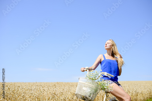 Photos Young beautiful blonde lady on bicycle exposing her face to sun