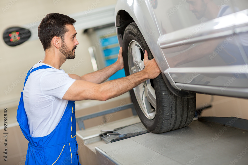 handsome mechanic changing a tire handsome mechanic changing a tire