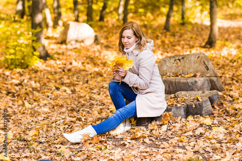 pretty woman relaxing in the autumn park