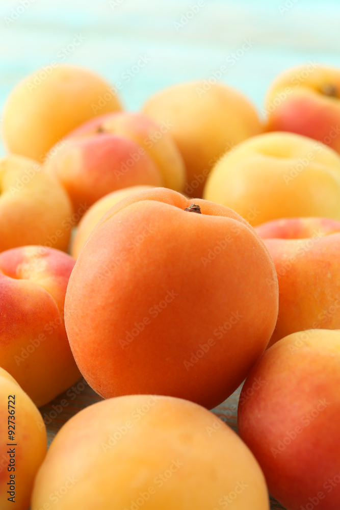 Heap of ripe apricots on wooden table close up Heap of ripe apricots on wooden table close up