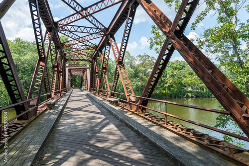 Fototapeta Naklejka Na Ścianę i Meble -  Pedestrian Rail Trail crosses the Springtown Bridge over the Wallkill River in Upstate NY Near New Paltz on a bright summer day.