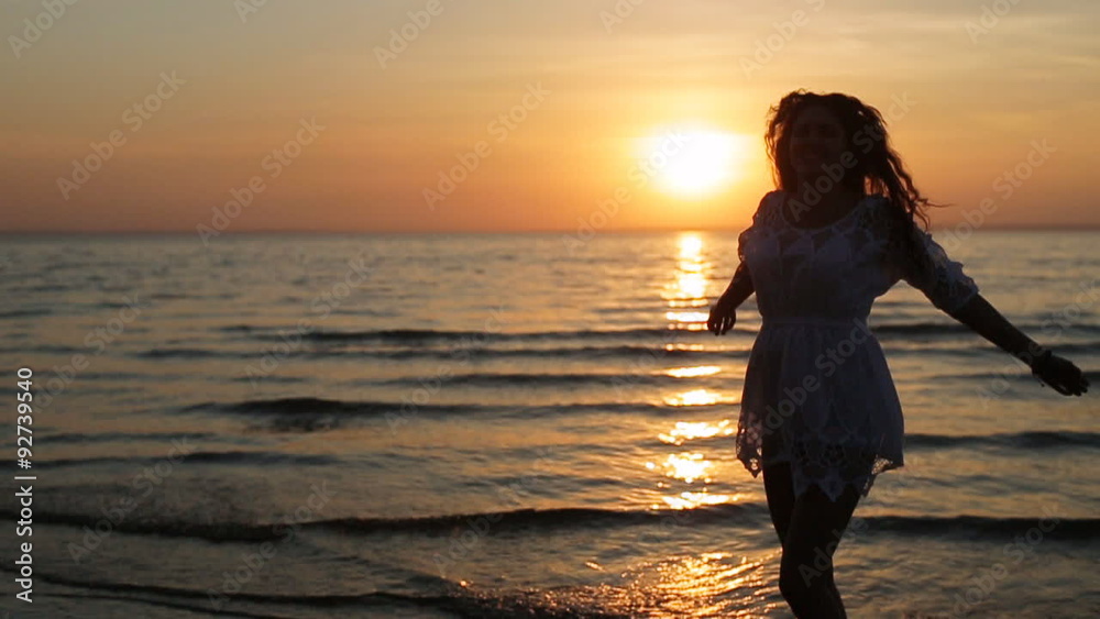 woman silhouette dancing and jumping on sunset beach woman silhouette dancing and jumping on sunset beach