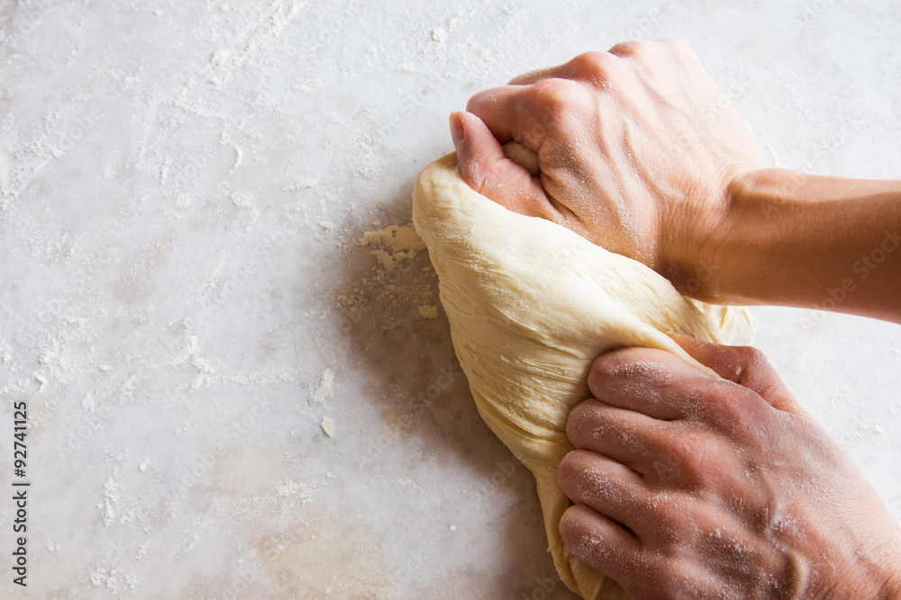 Fototapeta premium Hands kneading dough
