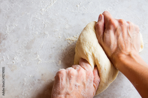 Hands kneading dough photo