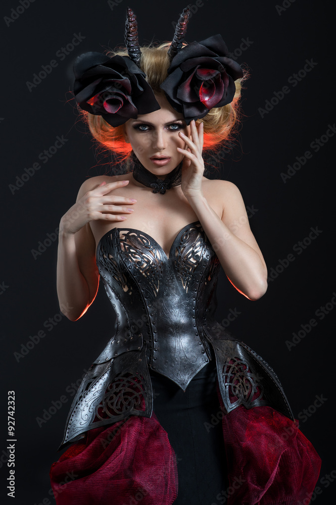 Portrait of beautiful blond woman in dark sexy corset in studio Portrait of beautiful blond woman in dark sexy corset in studio