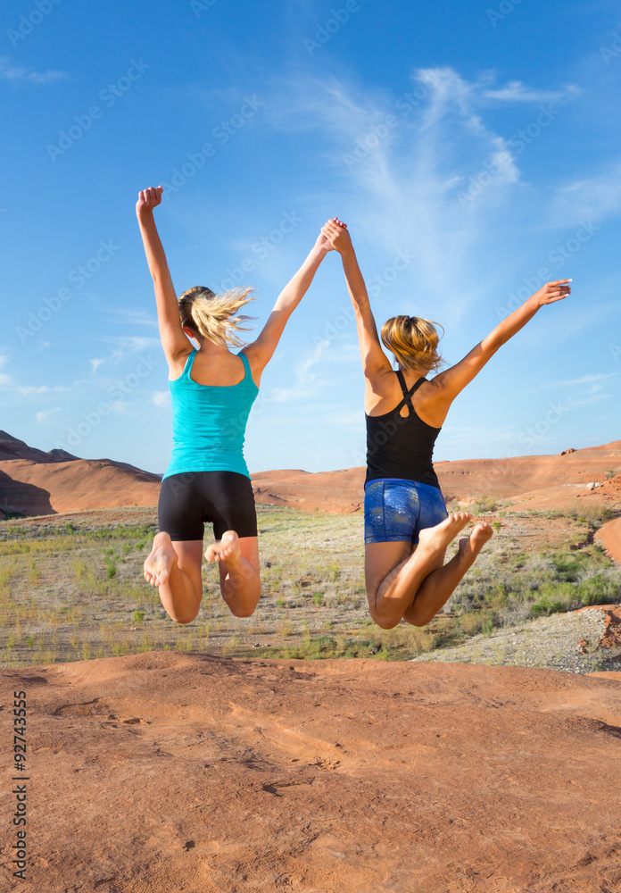 Two Girls Jumping for Joy in the Desert Two Girls Jumping for Joy in the Desert