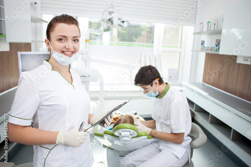 Professional male dental doctor is working with patient