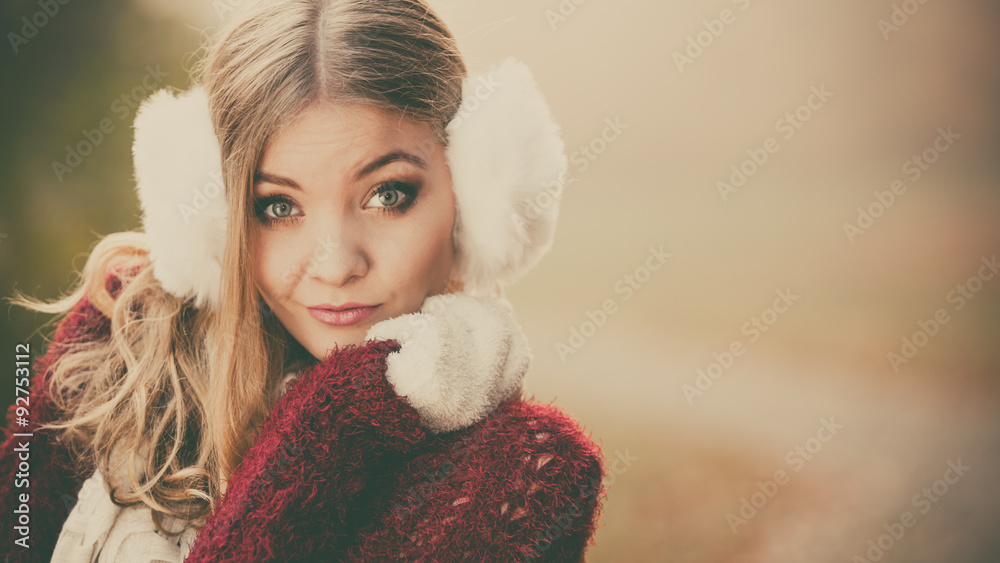 Portrait of pretty gorgeous woman in earmuffs. Portrait of pretty gorgeous woman in earmuffs.