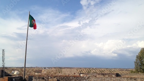 Flag of Portugal waving on top of Castro Marim Castle in Algarve, Portugal.