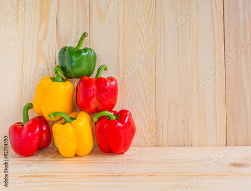 sweet peppers on wooden table background