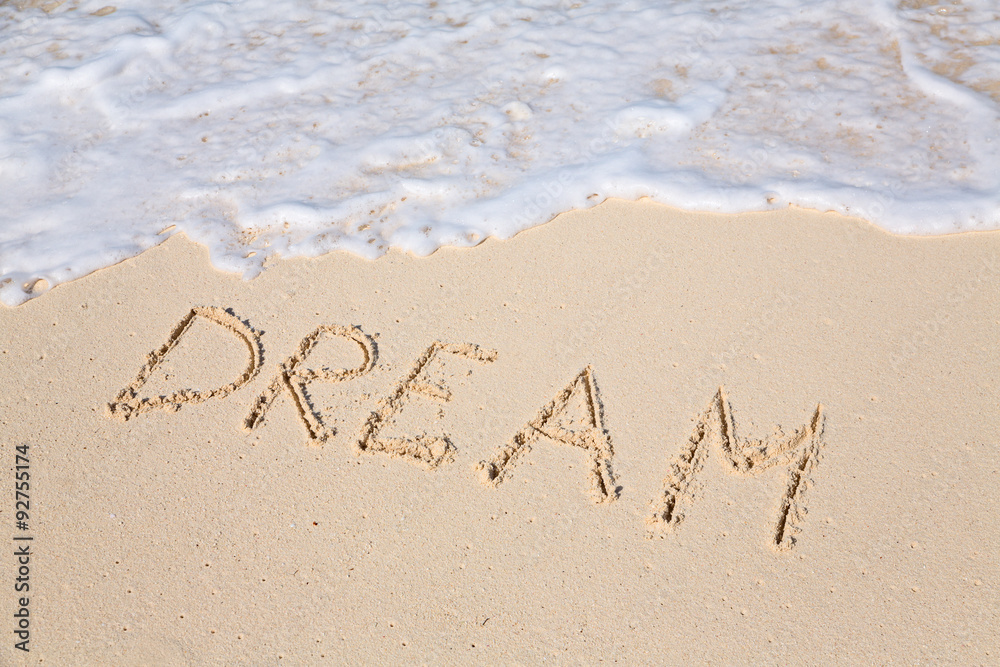 Fototapeta premium Word DREAM on beach - vacation concept background