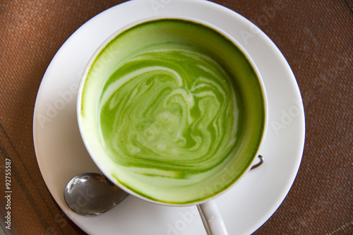 Close up hot Greentea matcha latte wood background