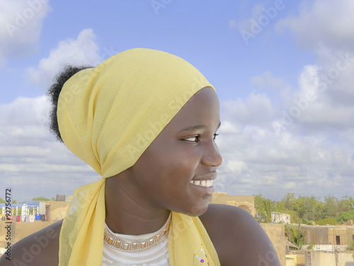 Afro teenager sitting on a terrace photo