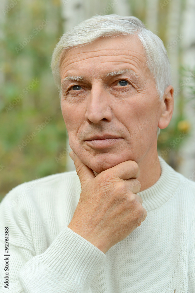 thoughtful senior man in park thoughtful senior man in park