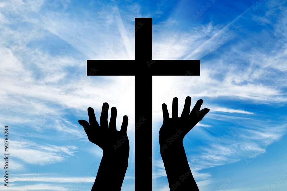  Silhouette of hands outstretched on the cross
