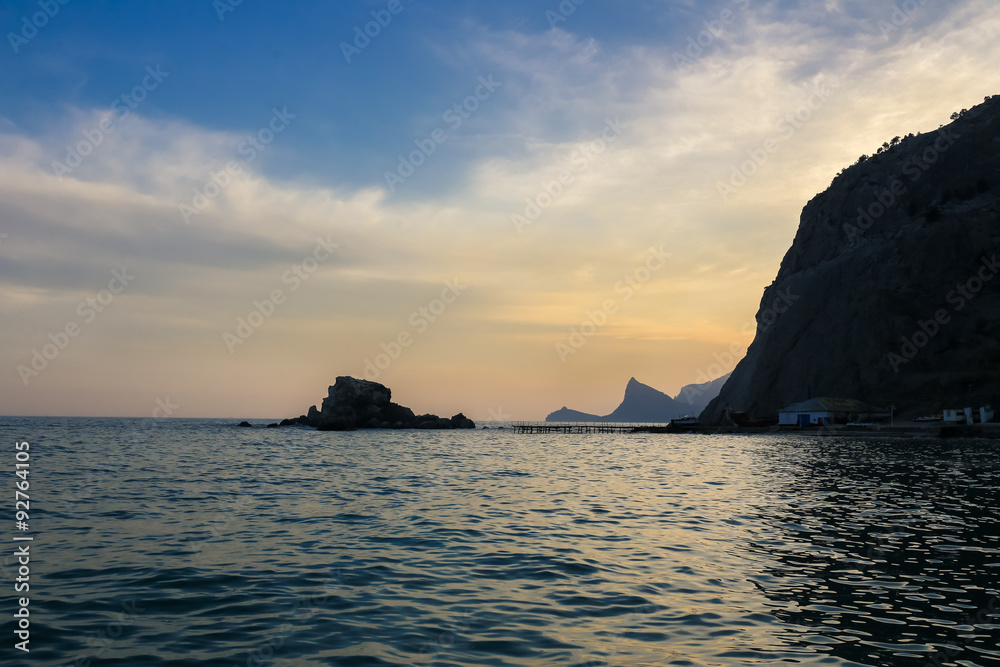 Seashore with cliffs at sunset sea sky rock coast