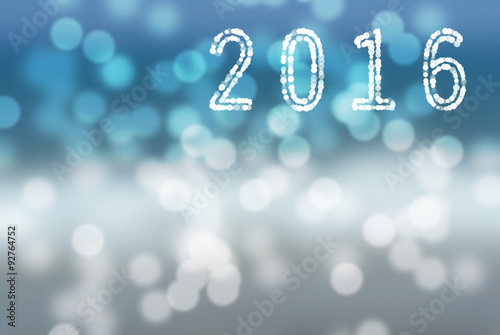 2016 New Year greeting card made of white shiny digits on blue and white bokeh background, with copyspace. Snow.
