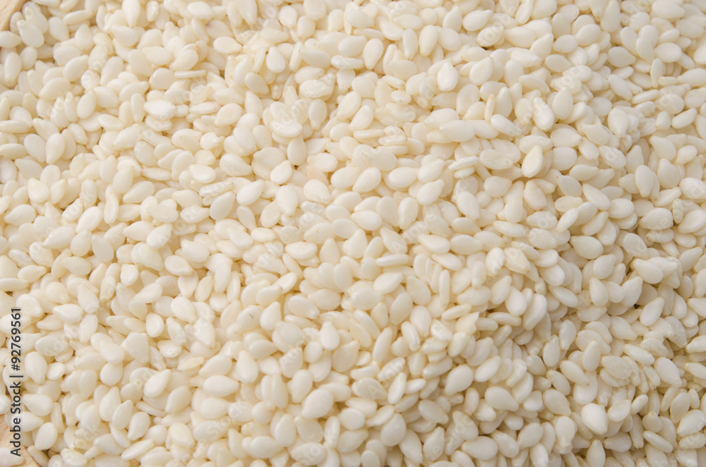 sesame seeds with wooden spoon